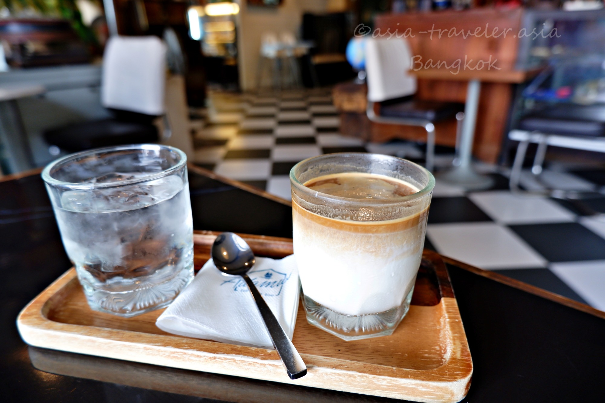 バンコクカフェのダーティーコーヒーと水が並ぶ木製トレー
