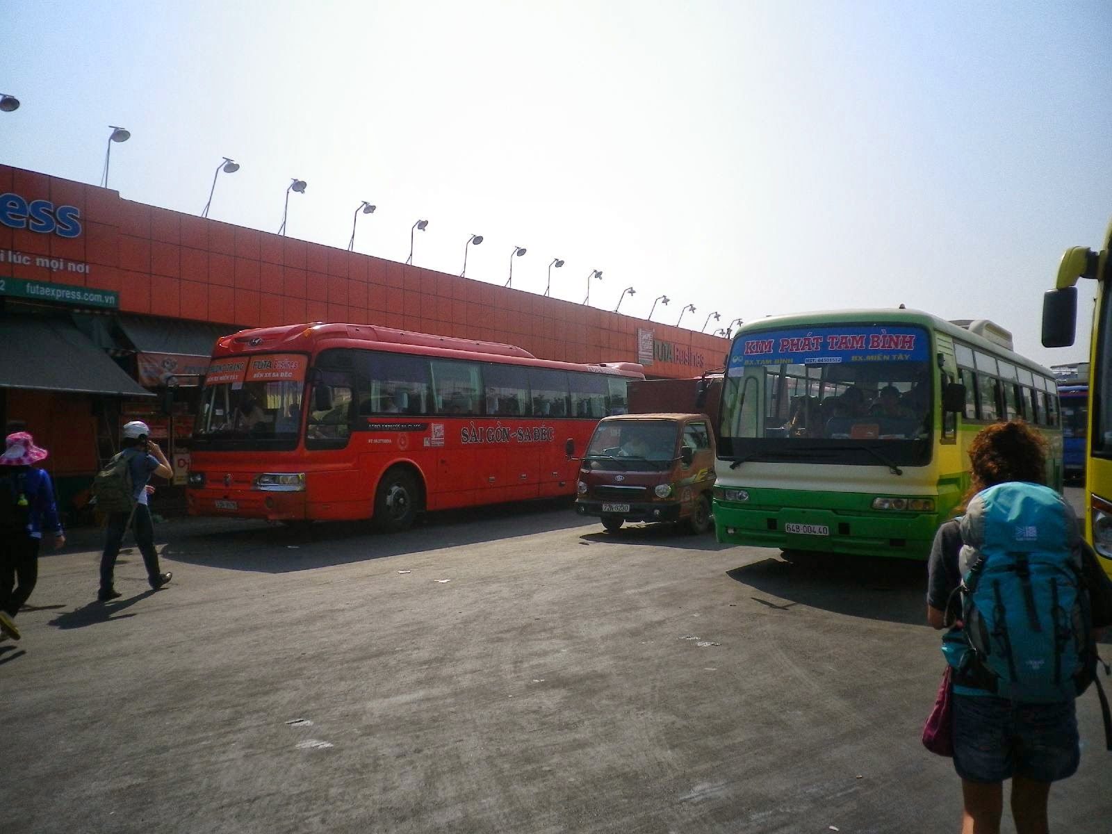 ホーチミンのバスターミナルに並ぶ長距離バスと旅行者