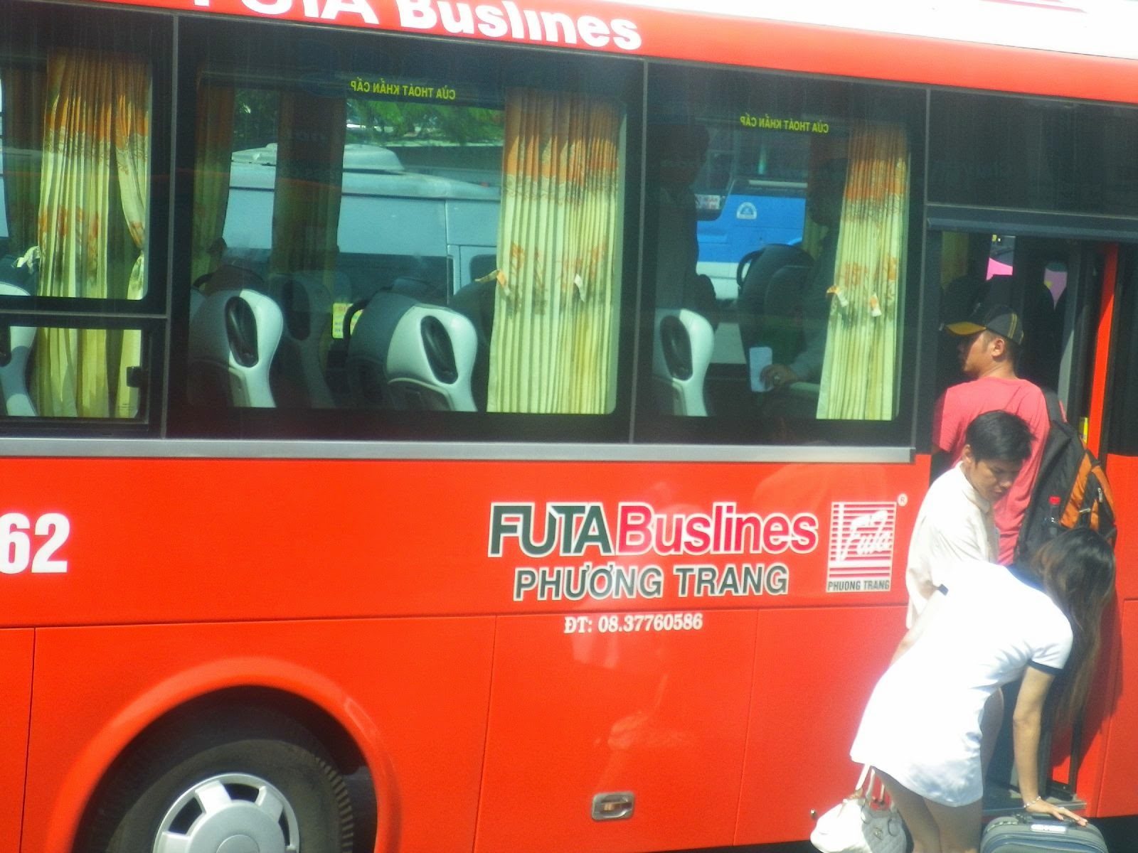 ベトナムFUTA Buslinesフーントランの赤いバスに乗り込む乗客