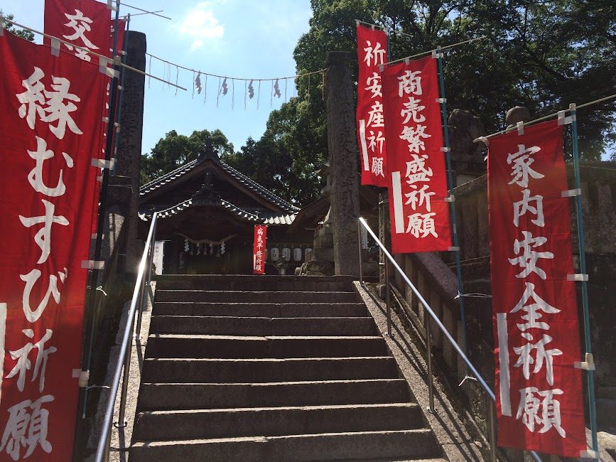 赤い幟が並ぶ神社の石段と拝殿